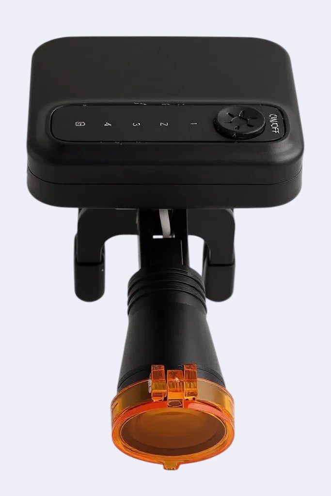 DENTISTOOLBOX black rechargeable headlamp with removable battery, adjustable brightness, and orange filter for dental use.